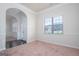 Bright and airy entryway with an arched hallway and view to the living room at 160 Traditions Ln, Hampton, GA 30228