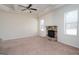Gathering room with stone fireplace and neutral color palette at 160 Traditions Ln, Hampton, GA 30228