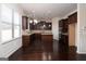 Eat-in kitchen with dark cabinets, granite counters, and island at 160 Traditions Ln, Hampton, GA 30228