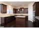 Spacious kitchen with dark cabinets, granite countertops, and island at 160 Traditions Ln, Hampton, GA 30228