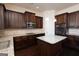 Spacious kitchen with dark cabinets, granite counters, and island at 160 Traditions Ln, Hampton, GA 30228