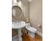 Elegant powder room featuring a pedestal sink and toilet at 116 Middleton Dr, Peachtree City, GA 30269