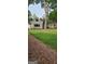 View of home's backyard with lush green lawn and trees at 213 W Hightower Trl, Social Circle, GA 30025