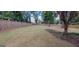 Expansive fenced backyard with lush lawn and garden beds at 213 W Hightower Trl, Social Circle, GA 30025