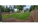 Large, fenced backyard with a green lawn and mature trees at 213 W Hightower Trl, Social Circle, GA 30025