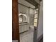 Bathroom doorway view shows vanity with granite countertop, framed mirror and marble subway tile at 213 W Hightower Trl, Social Circle, GA 30025