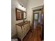 A charming bathroom featuring hardwood floors and unique vanity at 213 W Hightower Trl, Social Circle, GA 30025