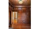 Charming bedroom featuring wood-paneled walls, wood floors and a unique, colorful stained glass light fixture at 213 W Hightower Trl, Social Circle, GA 30025