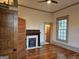 A bedroom with original hardwood floors, a decorative fireplace, and a door to an en suite bathroom at 213 W Hightower Trl, Social Circle, GA 30025