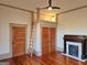 A bedroom with a unique loft space, accessed by a wooden ladder, as well as original hardwood floors and a fireplace at 213 W Hightower Trl, Social Circle, GA 30025