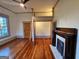 A bedroom featuring a unique loft space, original hardwood floors, a fireplace, and a modern ceiling fan at 213 W Hightower Trl, Social Circle, GA 30025