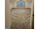 Carpeted attic bedroom featuring neutral walls, and a large arched window at 213 W Hightower Trl, Social Circle, GA 30025