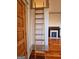 A bedroom featuring a wooden ladder to a loft space, original hardwood floors, and a decorative fireplace at 213 W Hightower Trl, Social Circle, GA 30025