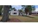 Charming home with light yellow siding, multiple windows, chimney, and well manicured lawn at 213 W Hightower Trl, Social Circle, GA 30025