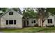 Side exterior of home with brick walkway, a lush garden, and mature landscaping at 213 W Hightower Trl, Social Circle, GA 30025