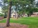 Spacious lawn with mature trees surrounding charming home in a serene setting at 213 W Hightower Trl, Social Circle, GA 30025