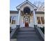 Elegant front entry with arched detail and wood door at 213 W Hightower Trl, Social Circle, GA 30025