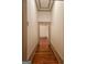 Long hallway with hardwood floors and neutral walls at 213 W Hightower Trl, Social Circle, GA 30025