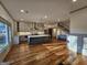 Spacious open-concept kitchen with center island, stainless appliances, and hardwood floors at 213 W Hightower Trl, Social Circle, GA 30025