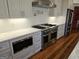 Modern kitchen featuring stainless steel appliances, custom cabinets, and a professional-grade gas range at 213 W Hightower Trl, Social Circle, GA 30025