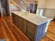 Large kitchen island with sink, drawers and storage facing stairs at 213 W Hightower Trl, Social Circle, GA 30025