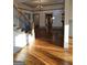 Bright living room featuring hardwood floors, decorative iron staircase, and an open floor plan at 213 W Hightower Trl, Social Circle, GA 30025