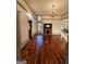 Living room with a decorative fireplace, original hardwood floors, neutral walls and trim, and backyard views at 213 W Hightower Trl, Social Circle, GA 30025