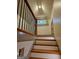 Top of the stairs with decorative wood and iron railing, and a stained glass window at the landing at 213 W Hightower Trl, Social Circle, GA 30025