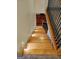 View from the top of the wooden staircase, showing the decorative iron railing, and carpeted landing at 213 W Hightower Trl, Social Circle, GA 30025