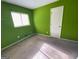 Simple bedroom with lime green walls and a window at 2655 West Rd, Riverdale, GA 30296