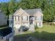 Two-story house with a landscaped lawn and attached garage at 7166 Thunder Rdg, Jonesboro, GA 30236