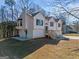 White two-story house with gray double garage, wooden deck and stairs at 2141 Colony Dr, Canton, GA 30114