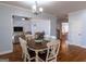 Dining room features wood floors and table with seating for six at 108 Turnberry Trce, Sharpsburg, GA 30277