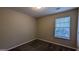 Bright bedroom with neutral walls, carpet flooring, and a window with blinds at 6627 Coventry Pt, Austell, GA 30168