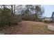 Large backyard with mature trees and a deck at 6627 Coventry Pt, Austell, GA 30168
