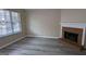 Living room featuring a brick fireplace and vinyl flooring at 6627 Coventry Pt, Austell, GA 30168