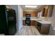 Kitchen with dark cabinets, black appliances, and vinyl flooring at 6627 Coventry Pt, Austell, GA 30168