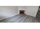 Living room with fireplace and grey wood-look flooring at 6627 Coventry Pt, Austell, GA 30168