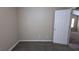 Bedroom with neutral walls, carpet flooring, and an open door at 6627 Coventry Pt, Austell, GA 30168