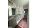 Well-lit bathroom features a double vanity with granite counters and large mirrors at 142 Asa Moseley Rd, Mcdonough, GA 30252