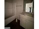 Bright bathroom features a white vanity with granite counters and a shower-tub combo at 142 Asa Moseley Rd, Mcdonough, GA 30252