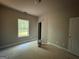 Unfinished bedroom with a window allowing natural light to stream into the space at 142 Asa Moseley Rd, Mcdonough, GA 30252