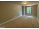 Unfinished bedroom with light, neutral-painted walls, window, and simple overhead lighting at 142 Asa Moseley Rd, Mcdonough, GA 30252