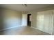 Spacious bedroom featuring neutral walls, a closet, and an open door at 142 Asa Moseley Rd, Mcdonough, GA 30252
