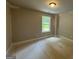 Unfinished bedroom with light, neutral-painted walls, a simple window, and overhead lighting at 142 Asa Moseley Rd, Mcdonough, GA 30252