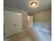 Bedroom with a double door closet and simple lighting with door that leads to another room at 142 Asa Moseley Rd, Mcdonough, GA 30252