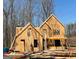 Framing of a new two-story home in a wooded setting with clear blue skies at 142 Asa Moseley Rd, Mcdonough, GA 30252