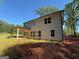Rear exterior of home featuring multiple windows and a covered patio, providing an ideal outdoor living space at 142 Asa Moseley Rd, Mcdonough, GA 30252