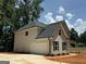 Side of new construction home with a garage and a mixture of sidings at 142 Asa Moseley Rd, Mcdonough, GA 30252