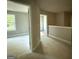 Hallway with white trim, doors, and a view into rooms with natural light at 142 Asa Moseley Rd, Mcdonough, GA 30252